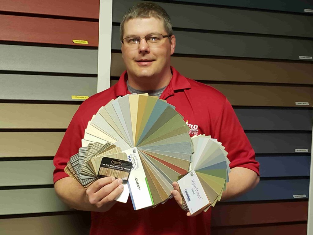 (Andy displaying just some of the siding options available at Astro U.P. in Rock)