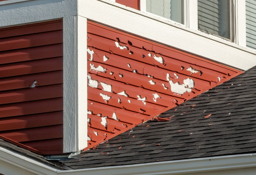 house with vinyl siding with holes and cracks